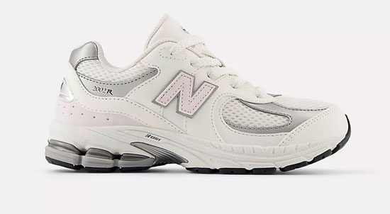 Supportive New Balance shoe with laces and white and pink color for girls.