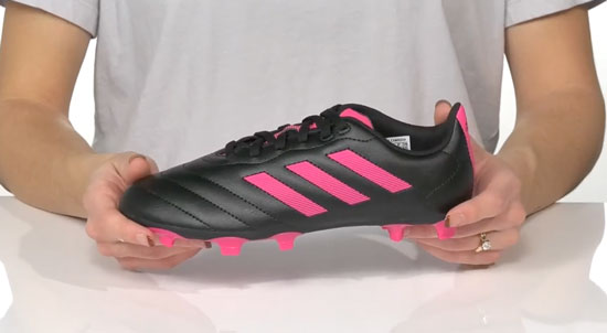 Supportive Adidas in black and pink soccer cleat for kids.