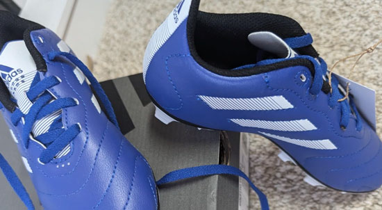 Supportive Adidas soccer cleat in navy blue for boys.