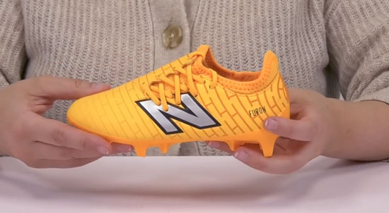 Supportive New Balance kids soccer cleat for kids with wide feet.