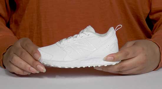 New Balance all white kids school shoe.