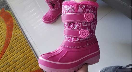 Pink kids' snow boots with double velcro straps and a side zipper.