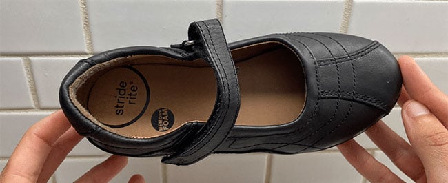 A pair of black leather Stride Rite Mary Jane shoes for kids.