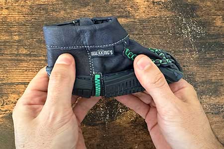 Soft, black, fabric unsupportive baby shoes for kids made by WalkKing's.