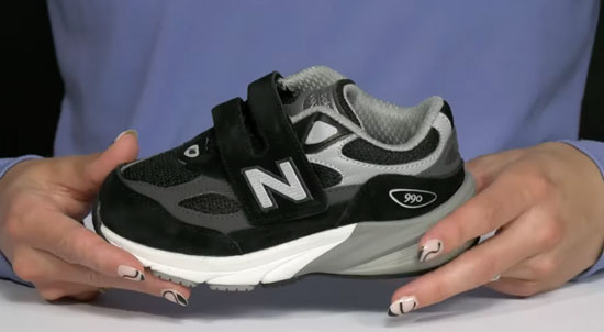 New Balance 990v6 toddler shoe in black and grey and with velcro closure.