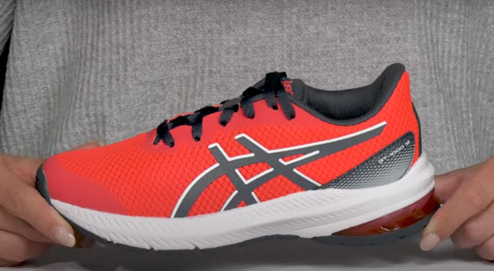 Supportive red Asics shoes for boys with flat feet.