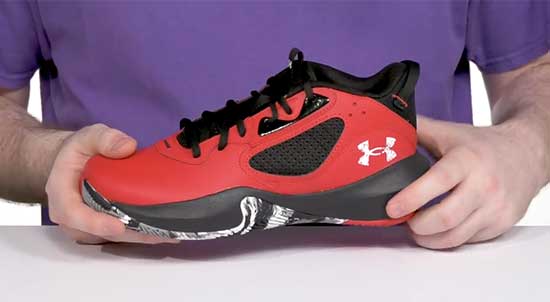 Red Under Armour basketball shoes for kids.