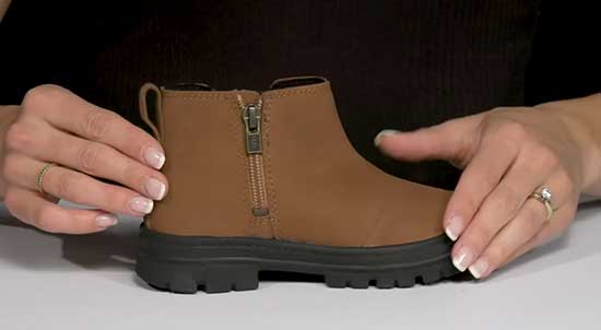 Waterproof Ugg boots for kids in brown with a side zipper.