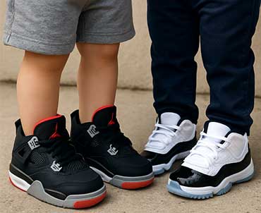 Toddlers wearing Jordan sneakers.