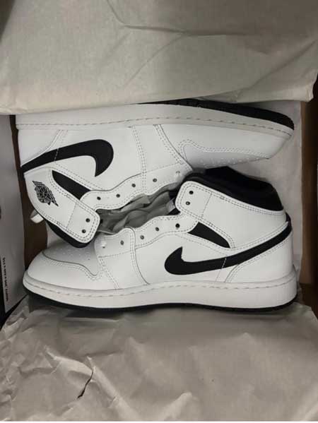 White and black wide Jordan shoes for kids.