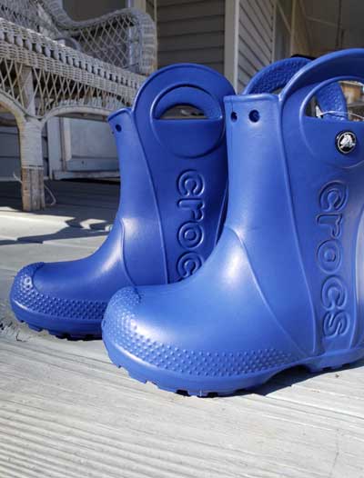 Blue toddler rain boots with side handles.