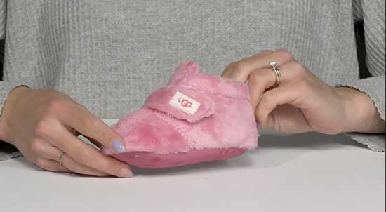 Pink newborn booties for babies.