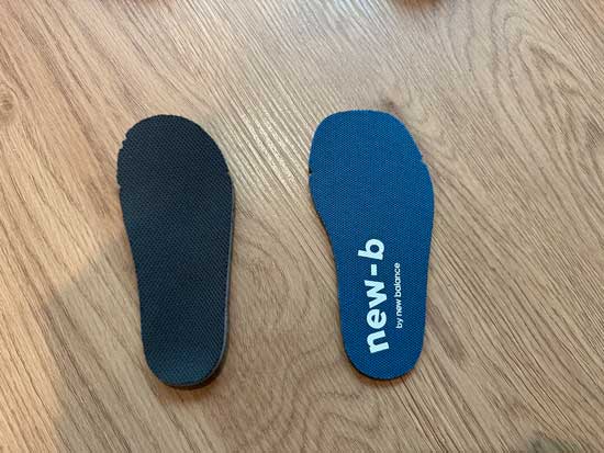 Two kids' insoles to help visualize the difference between wide and extra wide shoes.