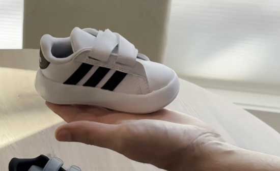 Classic white and black Adidas shoe for toddlers with wide feet.