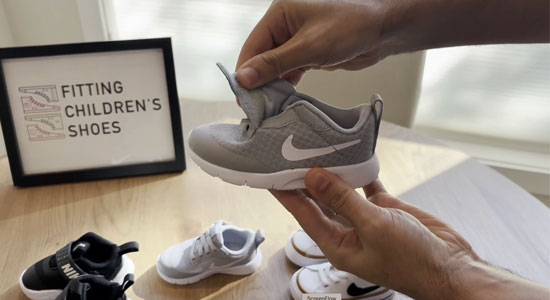 Wide Nike toddler shoe with oversized openings.