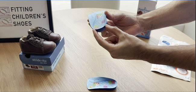 Footlogic 3/4-length orthotic with deep heel cups.