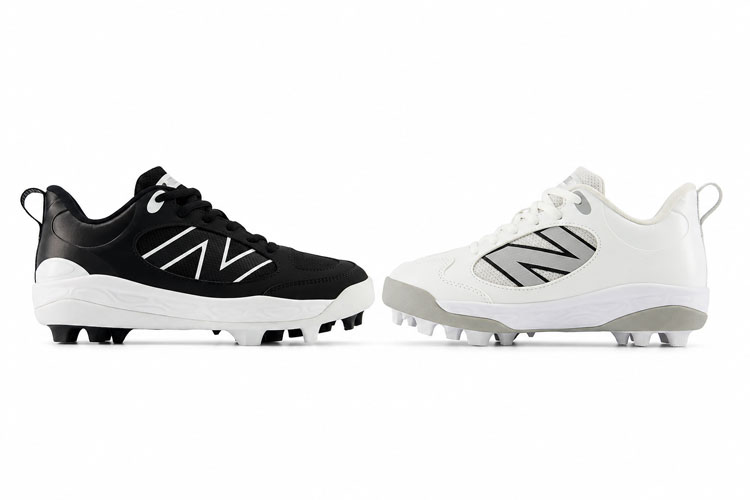 Black and white New Balance kids baseball cleats displayed side by side on a white background for color comparison.