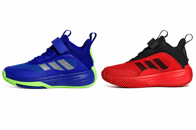 Blue and red Adidas kids' basketball shoes with Velcro straps for medium and wide feet displayed side by side on a white background.