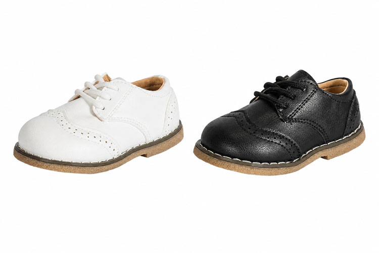 White and black kids wingtip dress shoes.