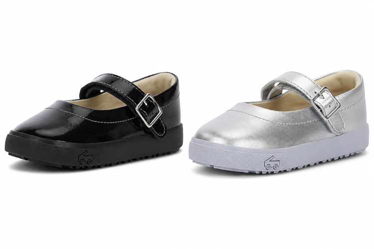 Black patent and silver See Kai Run Mary Jane shoes displayed side by side. Designed to fit children with wide feet, these dress shoes provide a roomy fit, secure adjustable strap, and all-day comfort.