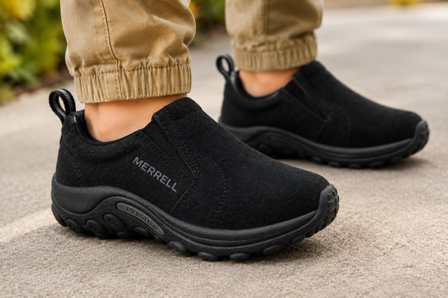 Black Merrell Jungle Moc slip-on shoes for kids.